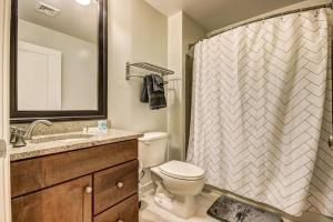 a bathroom with a toilet and a shower curtain at Chase at 39 West Convention Center Inner Harbor Free Parking in Baltimore