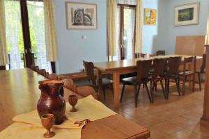 a dining room with a wooden table and chairs at Holiday home in Loka pri Zusmu Stajerska Untersteiermark 26086 in Loka pri Žusmu