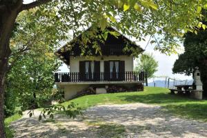 a house with a balcony and a bench in front of it at Holiday home in Loka pri Zusmu Stajerska Untersteiermark 26086 in Loka pri Žusmu