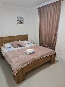 a bedroom with a bed with two towels on it at Apartments by the sea Nevidjane, Pasman - 8453 in Neviđane