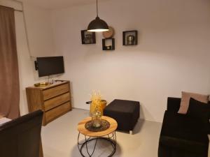 a living room with a table and a tv at Apartments by the sea Nevidjane, Pasman - 8453 in Neviđane