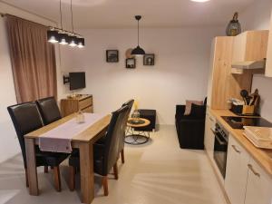 a kitchen and dining room with a table and chairs at Apartments by the sea Nevidjane, Pasman - 8453 in Neviđane