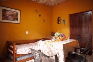 comedor con mesa, sillas y paredes amarillas en Departamento Inti Raymi en Tilcara