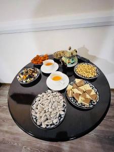 a table with many plates of food on it at Mutara Bukhara in Bukhara