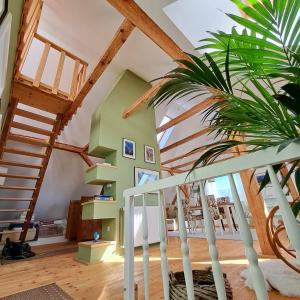 a house with wooden ceilings and a staircase at Entire Loft close to Beautiful Logar Valley in Rečica ob Savinji