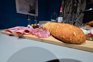 a sandwich and a loaf of bread on a cutting board at Luxury accommodation in Durham centre in Durham