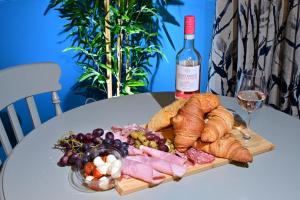 a plate of food on a table with a bottle of wine at Luxury accommodation in Durham centre in Durham