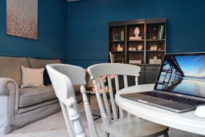 a living room with a table with a laptop on it at Luxury accommodation in Durham centre in Durham