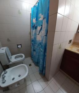 a bathroom with a toilet and a sink at Casa Privada Monte Grande y cochera in Monte Grande