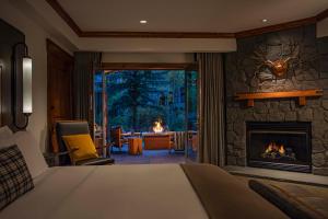 a bedroom with a fireplace and a living room at The Hythe, a Luxury Collection Resort, Vail in Vail