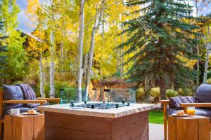 a fire pit in the middle of a yard with trees at The Hythe, a Luxury Collection Resort, Vail in Vail