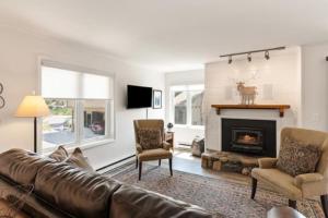 a living room with a couch and a fireplace at Easy Walk to Gondola-Elegant-Sunny-Updated Condo in Steamboat Springs
