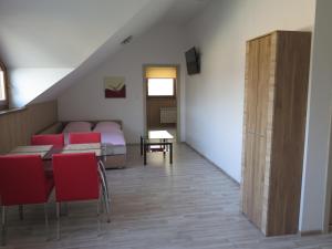 a room with a bed and a table and chairs at Penzion Fryštátská Chalupa in Karviná