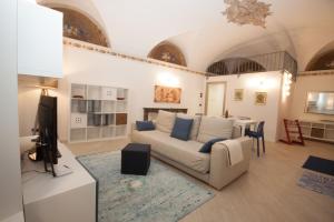 a living room with a couch and a tv and a table at Andalero - Palazzo Castelli in Menaggio