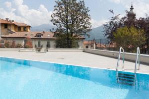 a swimming pool in a villa with mountains in the background at Andalero - Palazzo Castelli in Menaggio