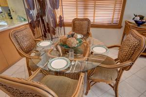 a dining room table with six chairs and a glass table at Lovely Gulf View Walk To Beach All Appliances in Bradenton Beach