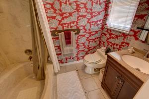 a bathroom with a toilet and a sink at Lovely Gulf View Walk To Beach All Appliances in Bradenton Beach