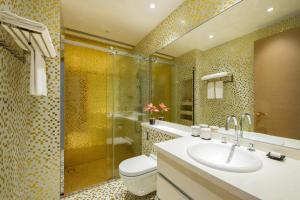 a bathroom with a toilet and a sink and a shower at The Clouds Apartment in Shenzhen