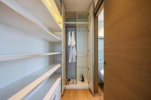 a walk in closet with a door and some shoes at The Clouds Apartment in Shenzhen