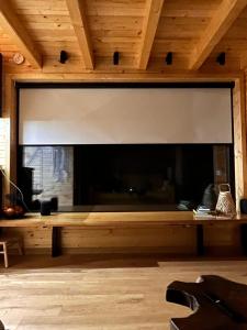a large fireplace in a room with a wooden ceiling at MoodySun Studio, remote tiny home in Comarnic +45 photos