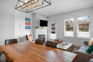 a dining room with a table and a fireplace at Beautiful Renovated Wolf 2Bed 2Bath in Canmore