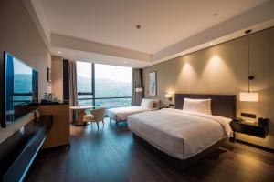 Postel nebo postele na pokoji v ubytování Fuzhou Mawei Yiho Hotel