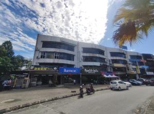 a large building with motorcycles parked in front of it at Bluemoon Boutique Hotel in Kuala Lumpur