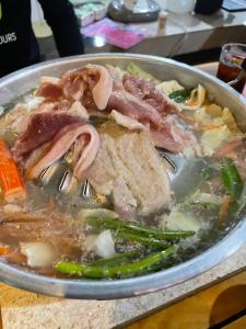 a bowl of soup with meat and vegetables on a table at โมวิชญ์นาคาธิบดีรีสอร์ท in Ban Don Klang +25 photos