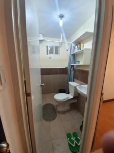 a small bathroom with a toilet and a sink at Arezzo Davao Near Sm Lanang & Airport in Davao City