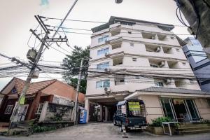 a building with a bus parked in front of it at We Residence Studio in Pattaya
