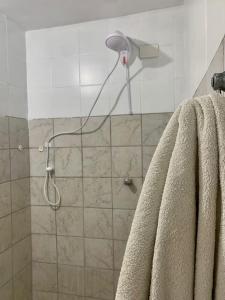 a shower with a shower head in a bathroom at Rua da Aurora in Recife