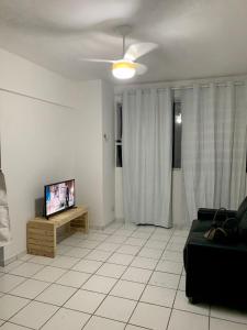 a living room with a couch and a flat screen tv at Rua da Aurora in Recife