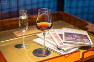 two glasses of wine sitting on a table at The Clouds Apartment in Shenzhen