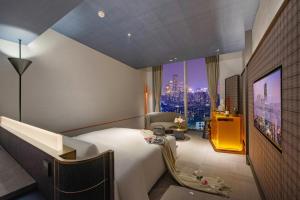 a hotel room with a bed and a view of a city at The Clouds Apartment in Shenzhen