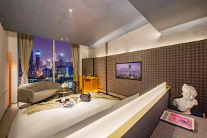 a hotel room with a bed and a view of a city at The Clouds Apartment in Shenzhen
