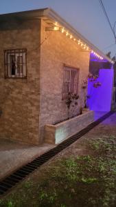 a building with purple lights on the side of it at Casa Luz Mi casa tu casa in Sabanitas