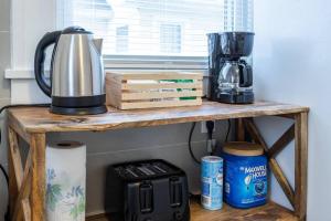 a wooden shelf with a coffee maker on it at Charming Steps to Strong/UofR by Airport/Dwnt/RIT in Rochester