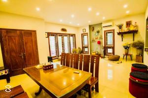 a living room with a wooden table and chairs at The Moonlight Villa in Sóc Sơn