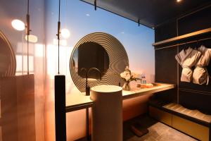 a bathroom with a sink and a mirror at The Clouds Apartment in Shenzhen