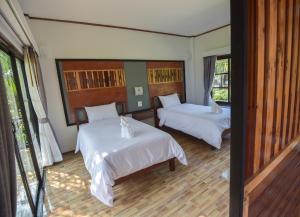 Palm Pran Resort客房内的一张或多张床位