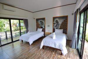 Palm Pran Resort客房内的一张或多张床位