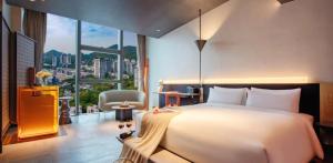 a bedroom with a large bed and a large window at The Clouds Apartment in Shenzhen