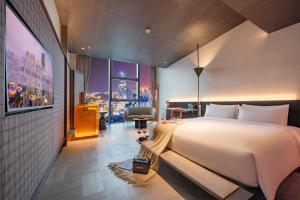 a bedroom with a large bed and a large window at The Clouds Apartment in Shenzhen