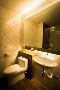 a bathroom with a toilet and a sink at Mandurah Hotel in Kuantan
