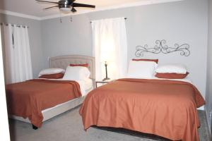 a bedroom with two beds and a ceiling fan at Adair Park Bungalow in Atlanta +16 photos