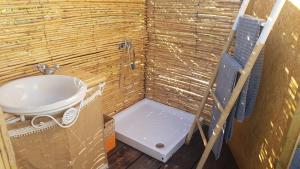 a small bathroom with a sink and a toilet at Sublim' Ecolodge in Abela