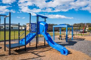 a playground with a blue slide in a park at Apollo Unit 12 Ground Floor in Narooma
