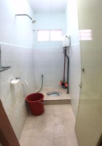 a bathroom with a toilet with a bucket in it at Ruhani Homestay 2 Kota Bharu Cheap and Comfortable in Kota Bharu