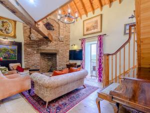 a living room with a couch and a fireplace at Seaton Court - Uk31955 in Staithes