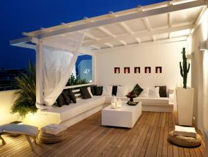 a living room with white furniture and a white canopy at Hotel Dory in Riccione